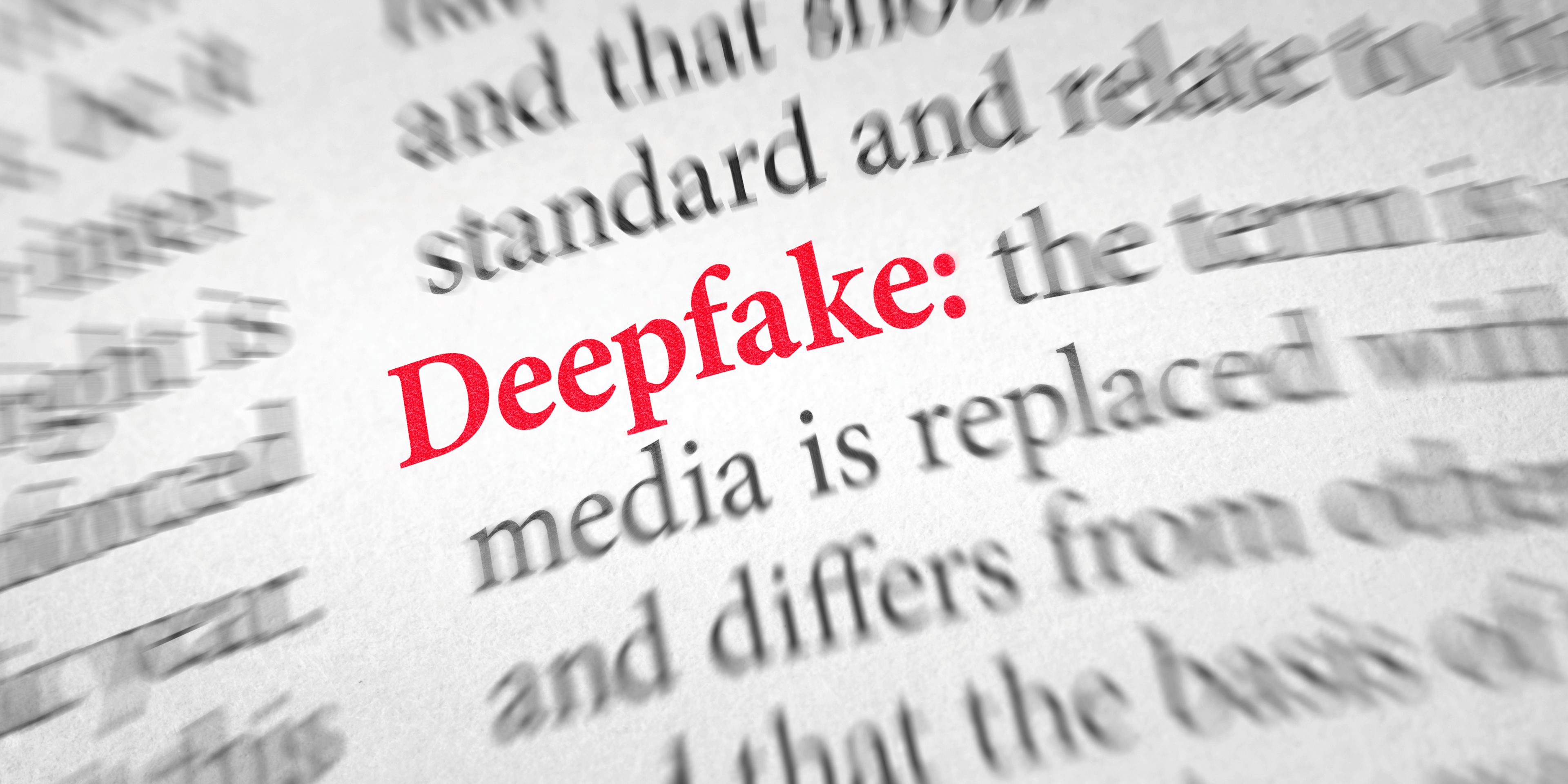 Deepfakes in 2026 — a dictionary close-up with the word "Deepfake" highlighted in red beside its definition
